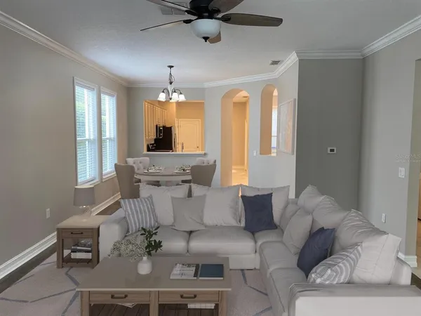 a living room with furniture and a chandelier