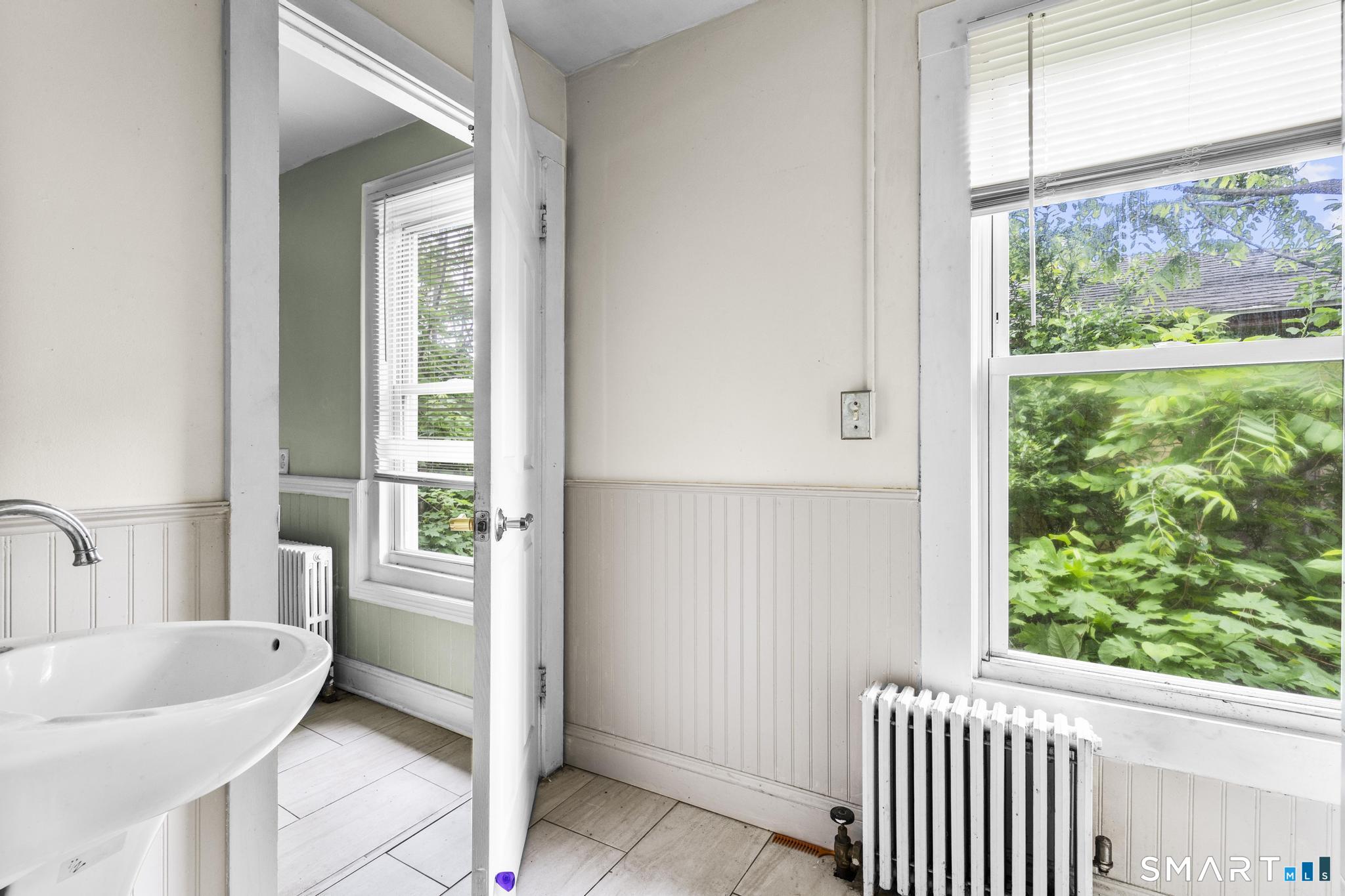 101 Meridian Street Meriden, CT 06451 - Photo 22 of 26 a bathroom with a bathtub and a sink