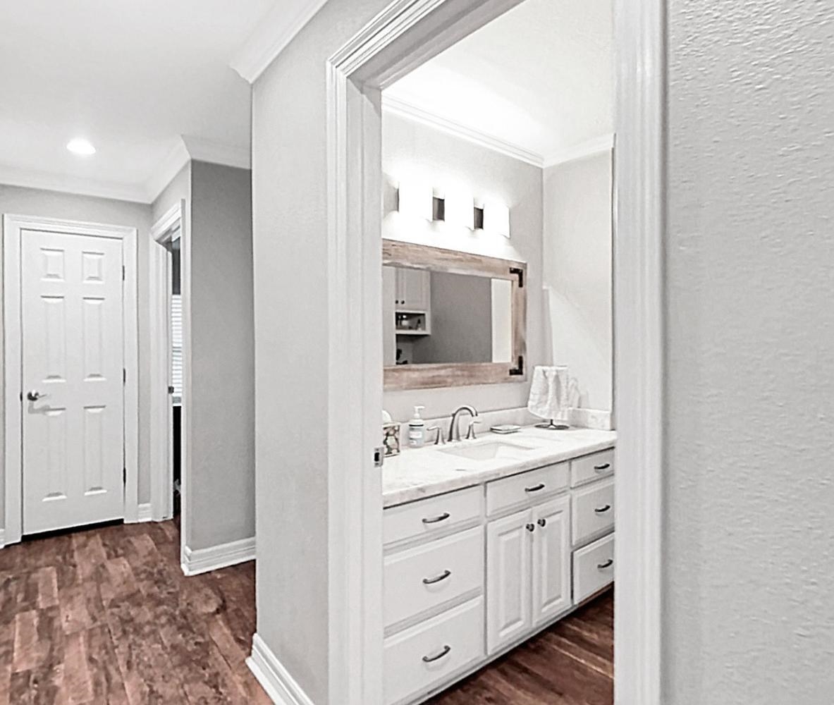 2641 Oilla Road Orange, TX 77630 - Photo 29 of 50 a spacious bathroom with a double vanity sink and mirror