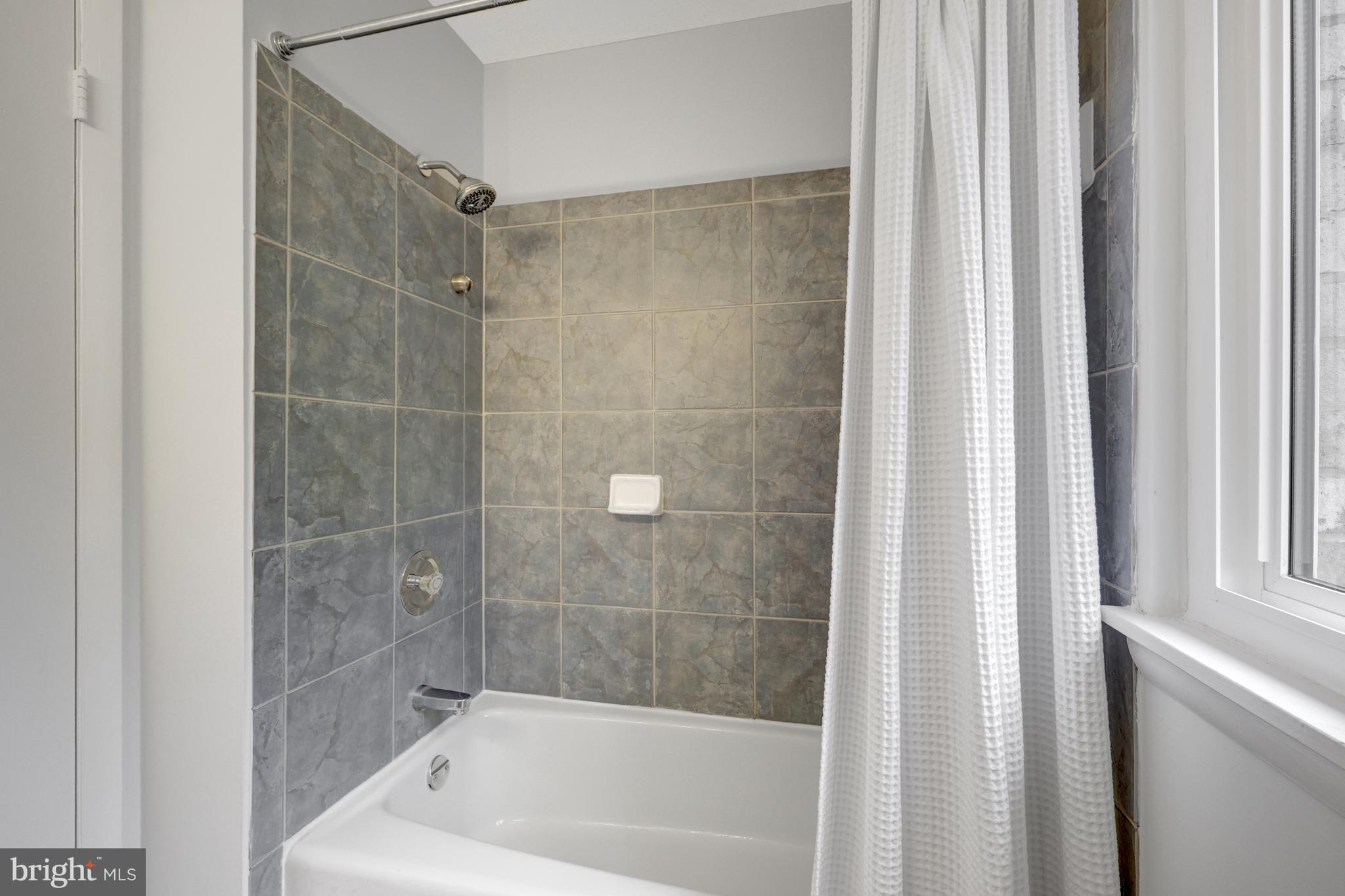 11063 Saffold Way Reston, VA 20190 - Photo 28 of 46 a bathroom with a bathtub and shower