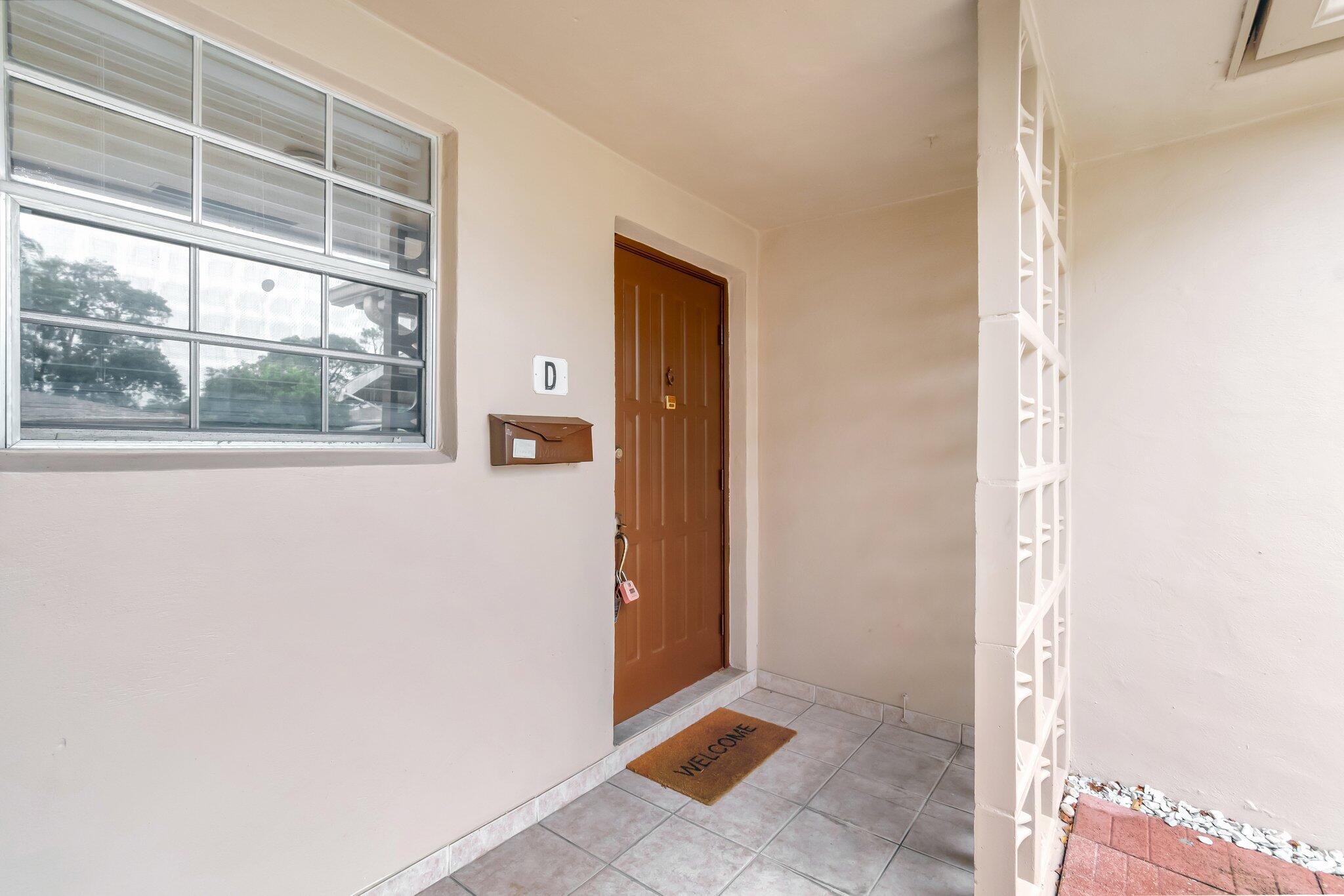 1375 High Point Way Southwest, Unit D Delray Beach, FL 33445 - Photo 3 of 54 Entranceway to villa (1)
