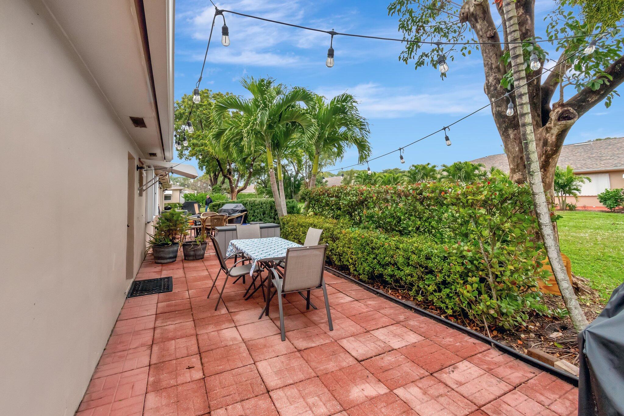 1375 High Point Way Southwest, Unit D Delray Beach, FL 33445 - Photo 36 of 54 Exterior rear patio and back yard view