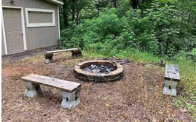 a view of a backyard with table and chairs