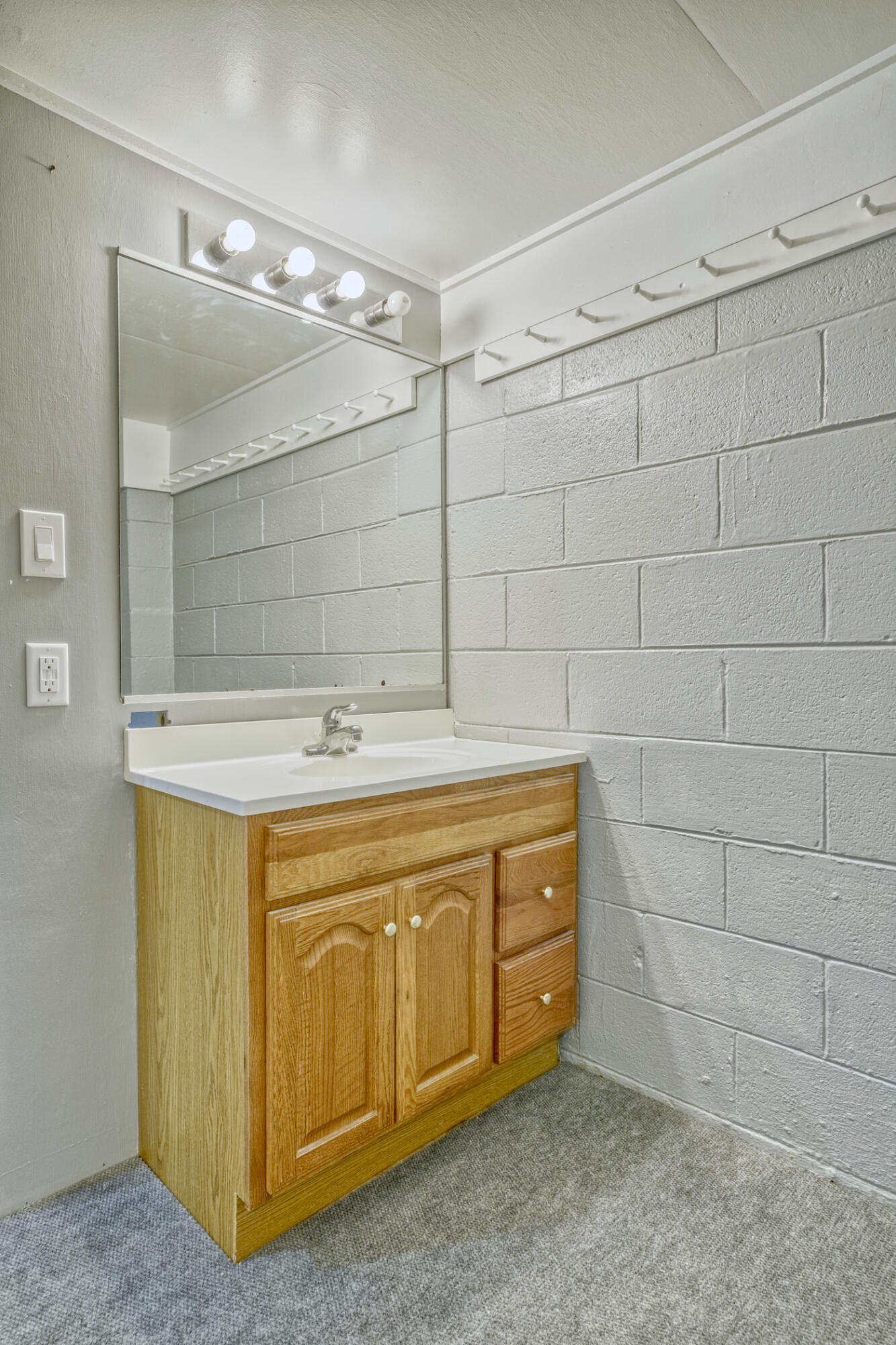 4912 West Main Street Lowell, IN 46356 - Photo 18 of 20 a bathroom with a sink and a mirror