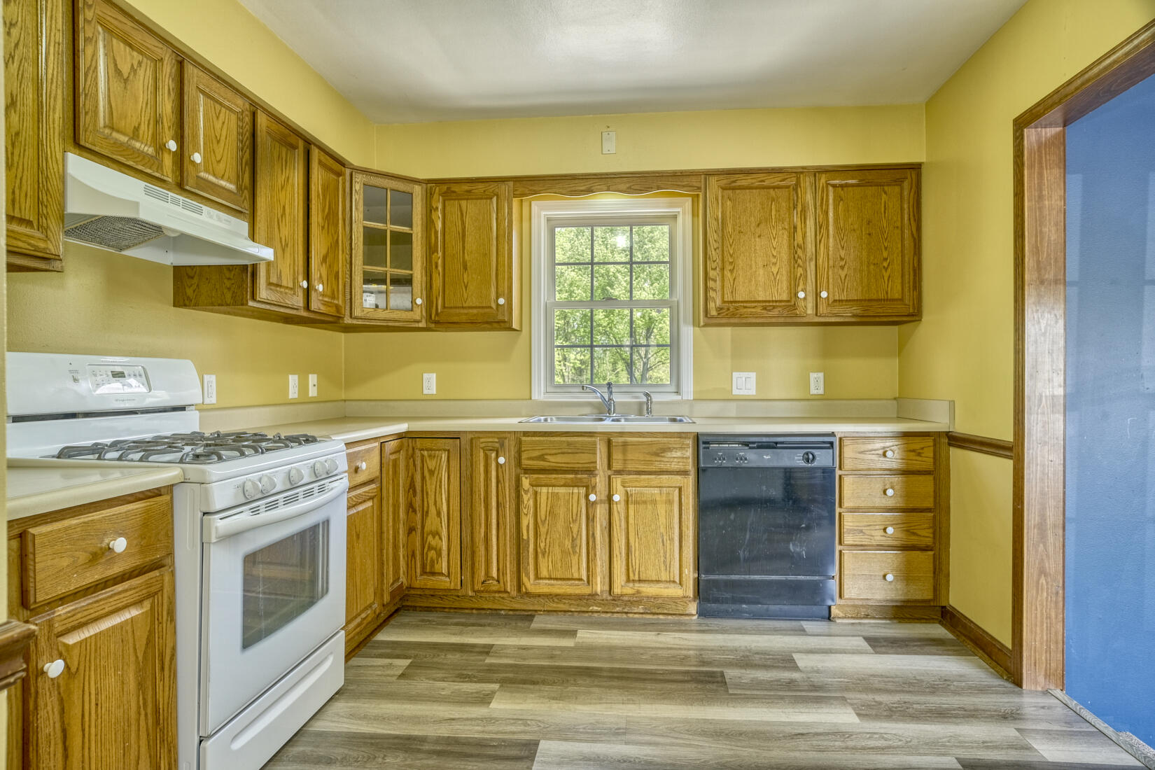 4912 West Main Street Lowell, IN 46356 - Photo 2 of 20 a bathroom with a granite countertop sink and dishwasher