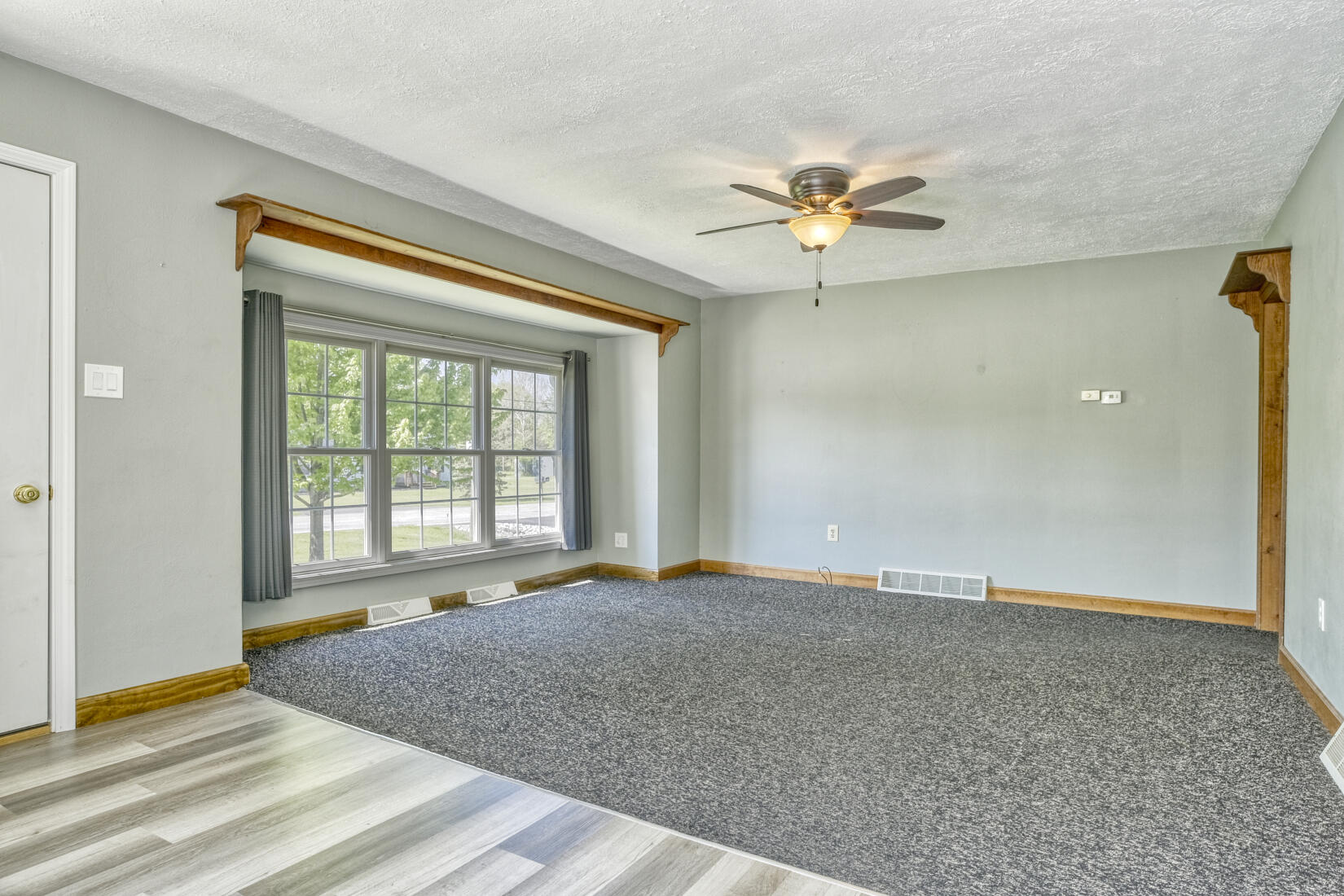 4912 West Main Street Lowell, IN 46356 - Photo 4 of 20 a view of an empty room with window and a ceiling fan