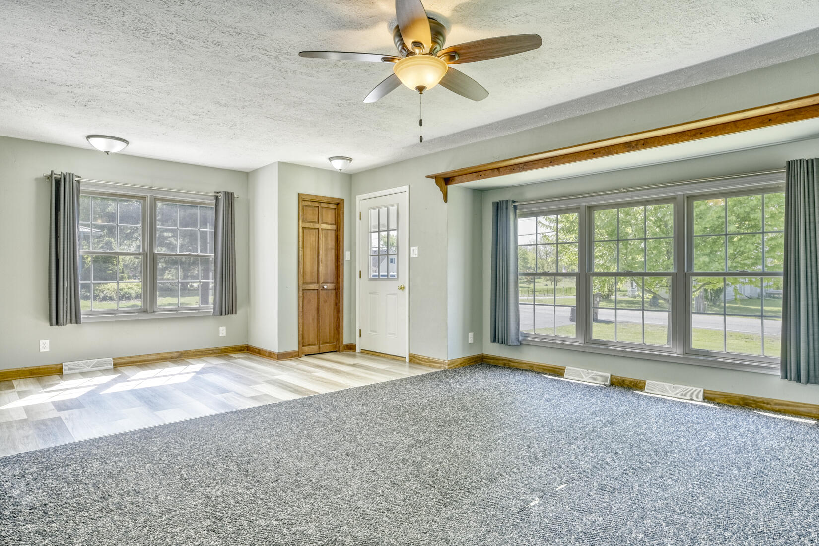 4912 West Main Street Lowell, IN 46356 - Photo 5 of 20 a view of an empty room with a window and a kitchen view