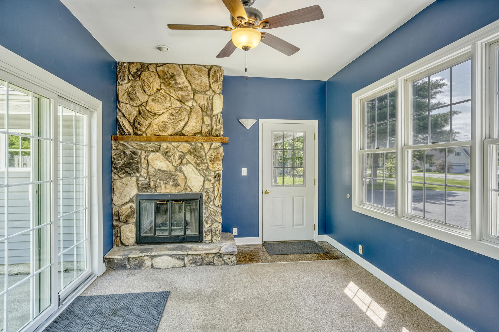 4912 West Main Street Lowell, IN 46356 - Photo 6 of 20 an empty room with windows and a fireplace