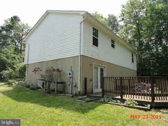 11555 Big Sandy Run Road Lusby, MD 20657 - Photo 2 of 3 a front view of a house with garden