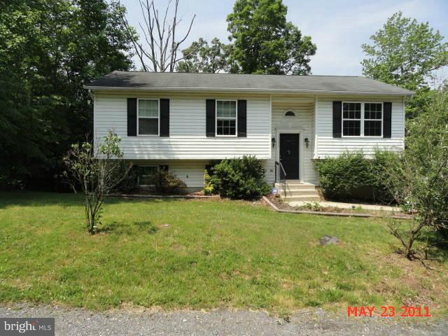 11555 Big Sandy Run Road Lusby, MD 20657 - Photo 3 of 3 a front view of a house with a yard