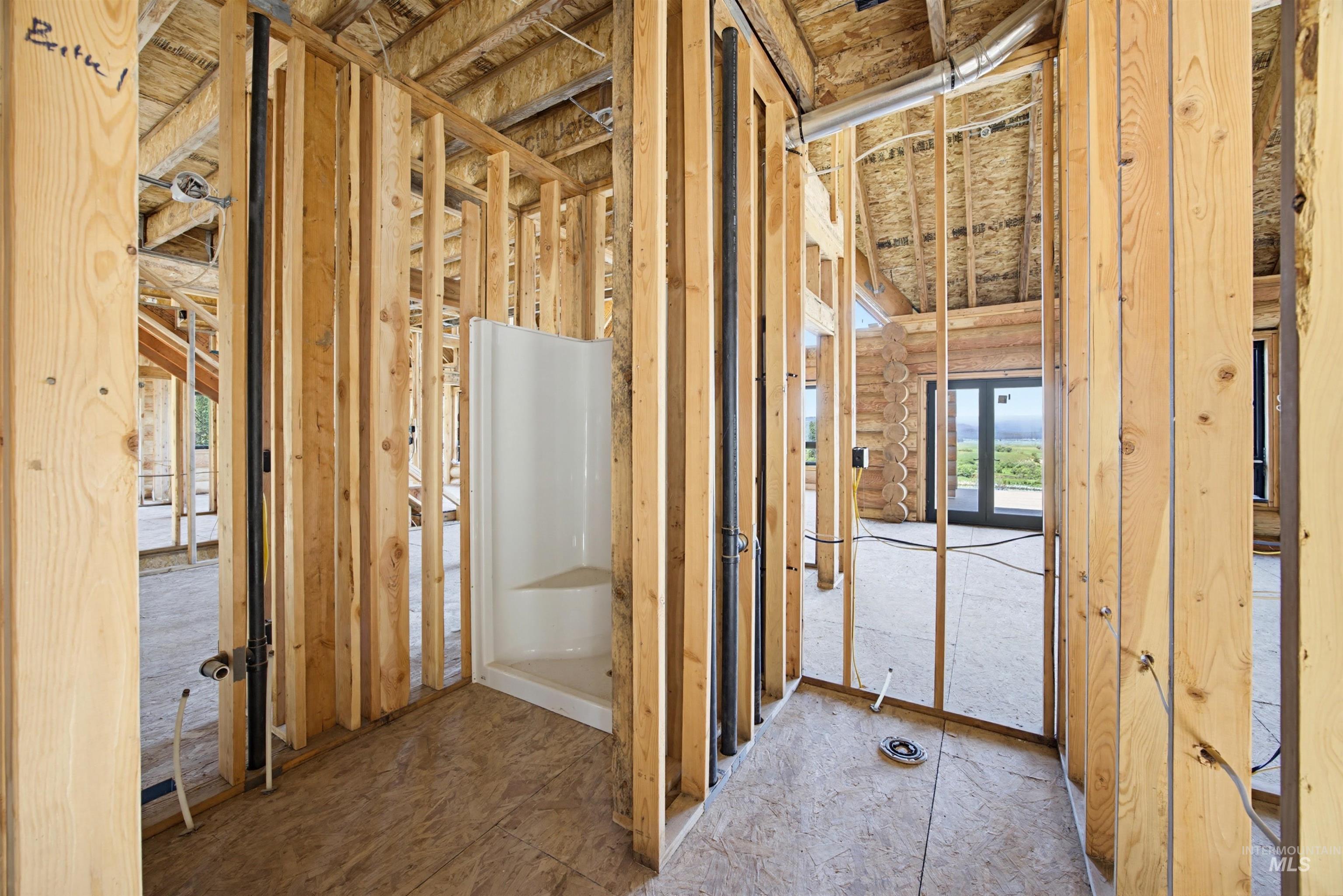 3322 Big Creek Road New Meadows, ID 83654 - Photo 26 of 50 New construction framing showcasing a pre-installed corner shower base and rough-in plumbing