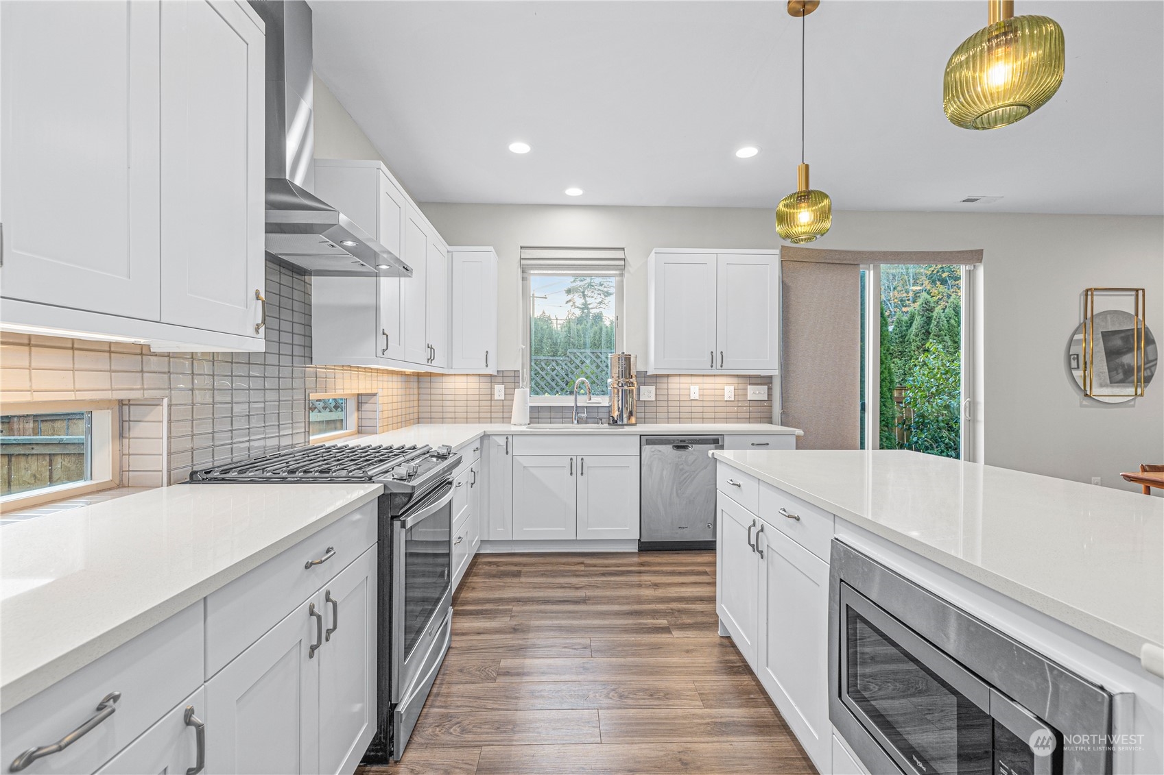 16614 Sylvester Road Southwest Burien, WA 98166 - Photo 13 of 40 a kitchen with a sink stove and cabinets