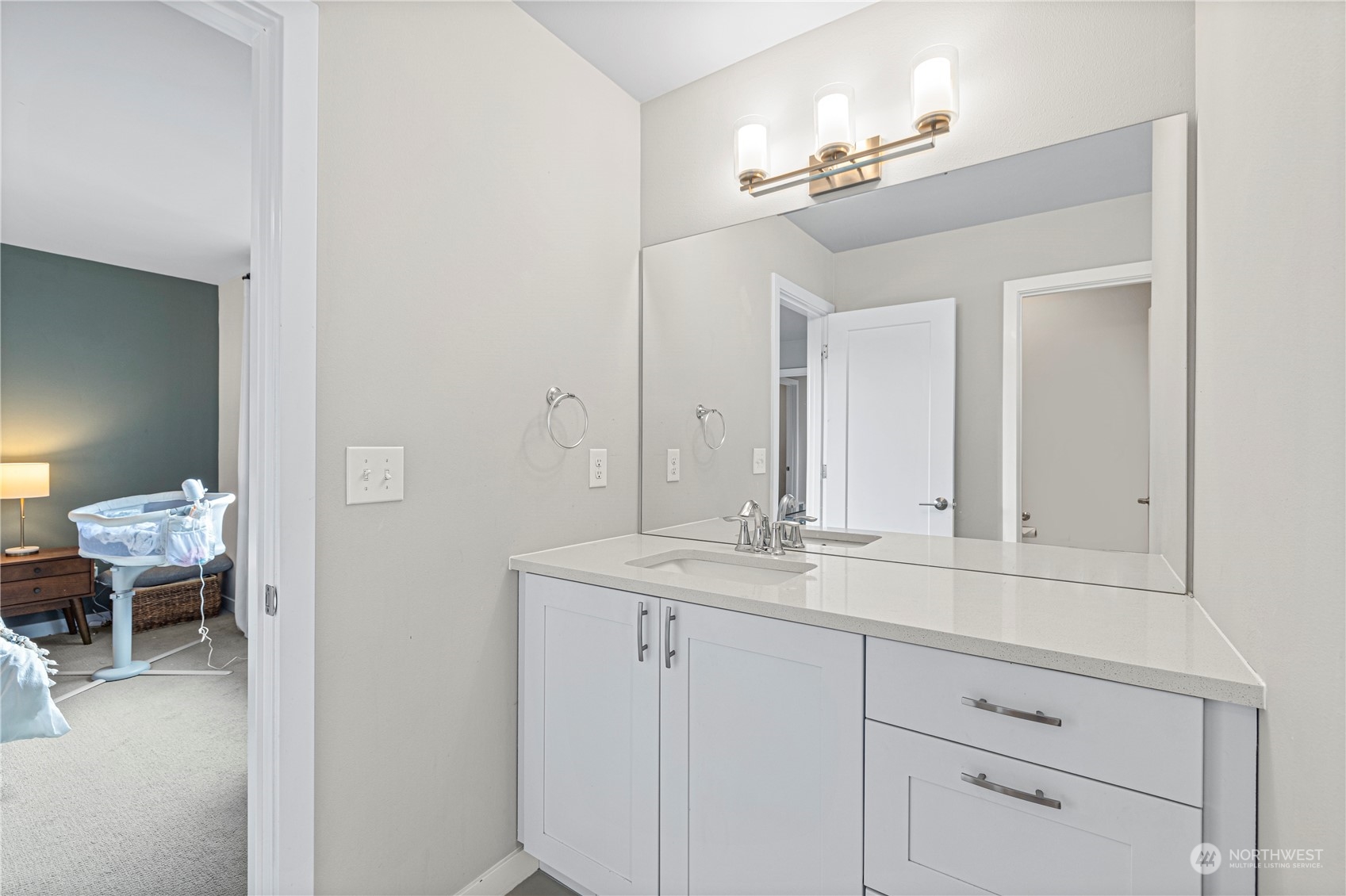 16614 Sylvester Road Southwest Burien, WA 98166 - Photo 23 of 40 a en suite bathroom with a double vanity sink and a mirror