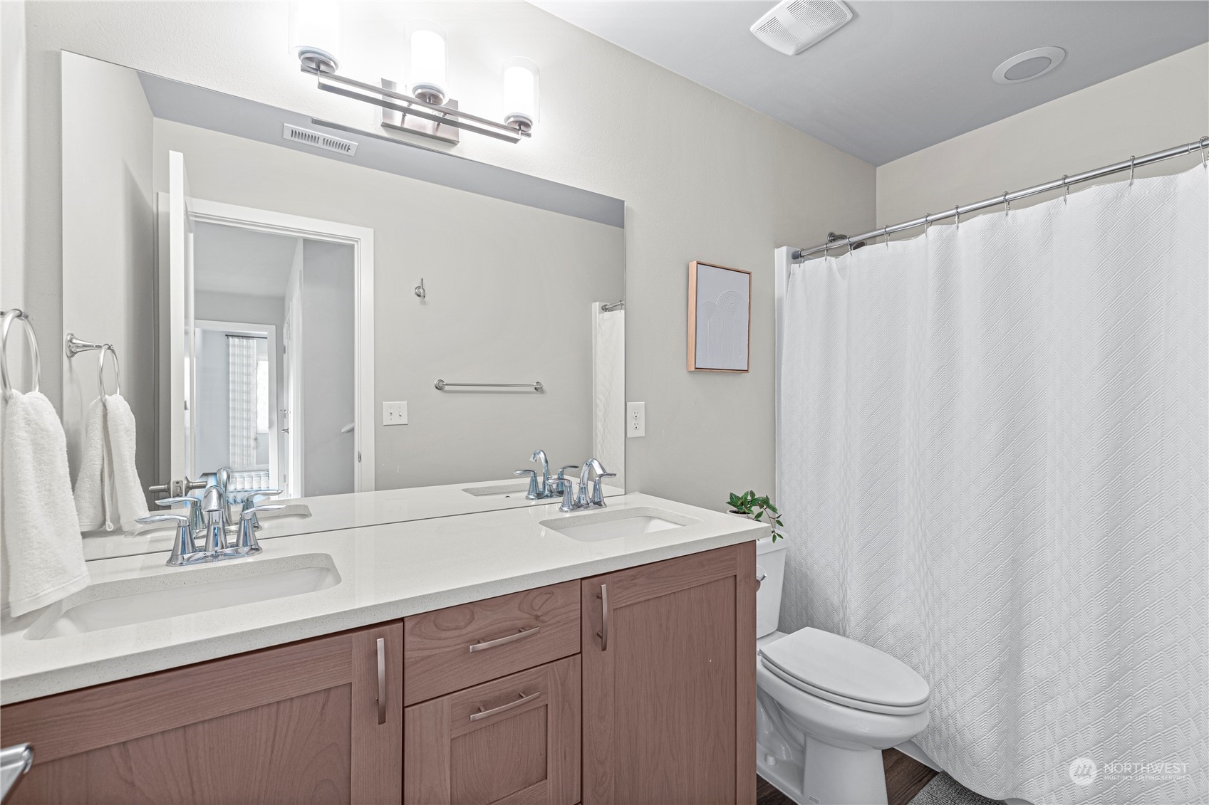 16614 Sylvester Road Southwest Burien, WA 98166 - Photo 28 of 40 a bathroom with a double vanity sink toilet and a mirror