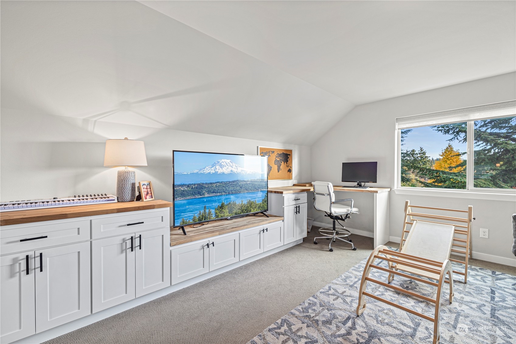 16614 Sylvester Road Southwest Burien, WA 98166 - Photo 32 of 40 a living room with furniture a flat screen tv and a floor to ceiling window