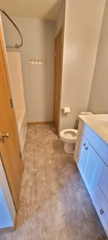 a bathroom with a sink a toilet a tub and shower