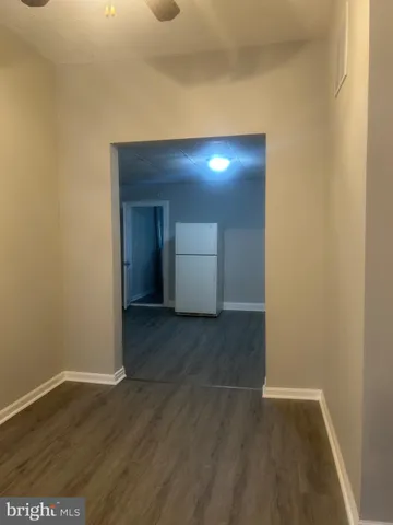 an empty room with wooden floor and door