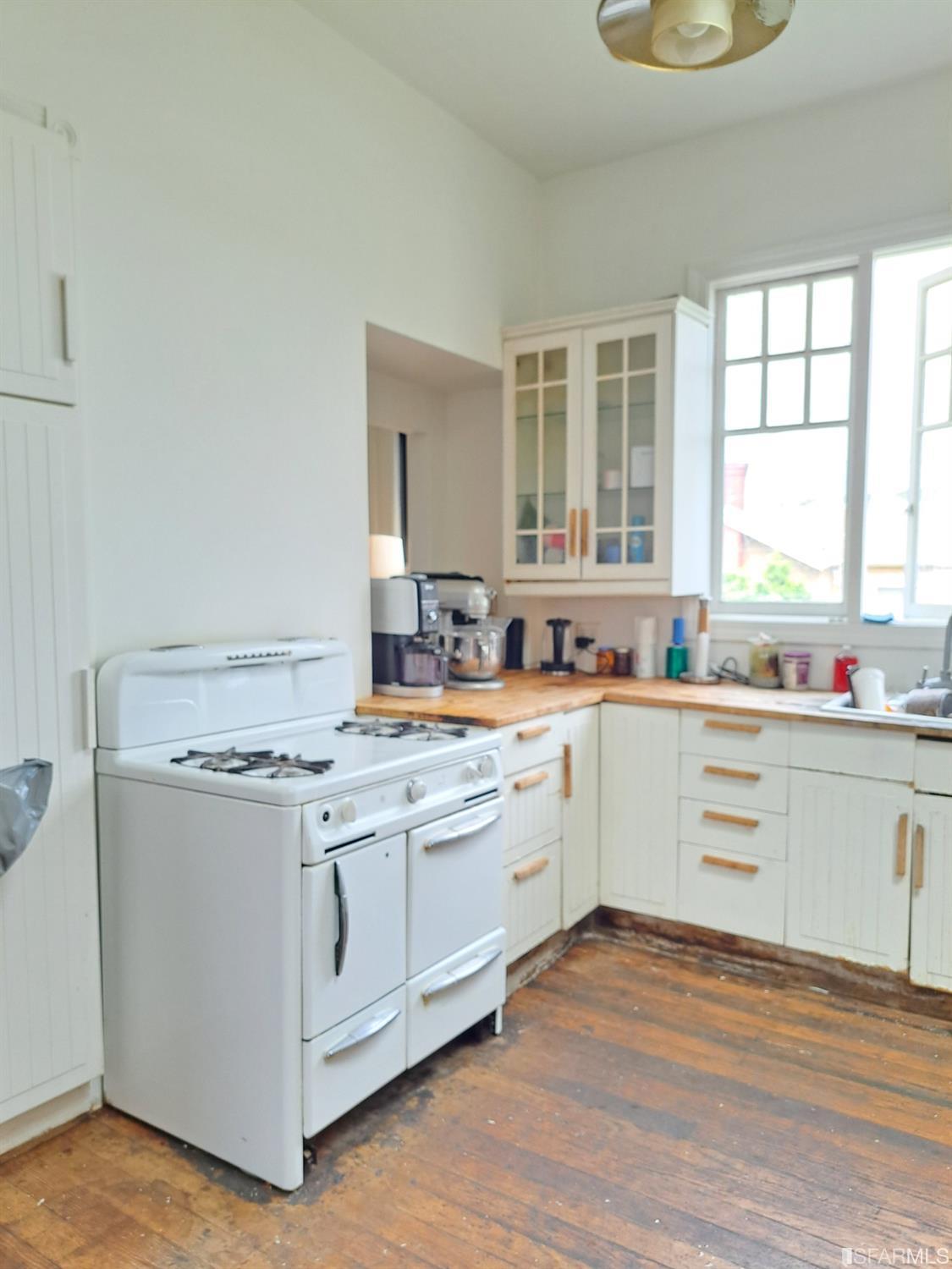1930 55th Avenue Oakland, CA 94621 - Photo 8 of 25 a kitchen with a stove a sink and a microwave