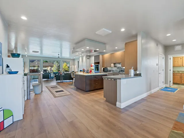 a view of kitchen with kitchen island and stainless steel appliances