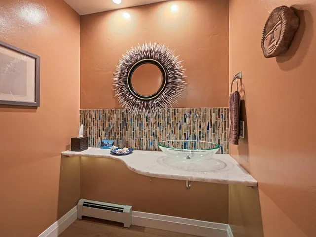 a room with a sink and a mirror