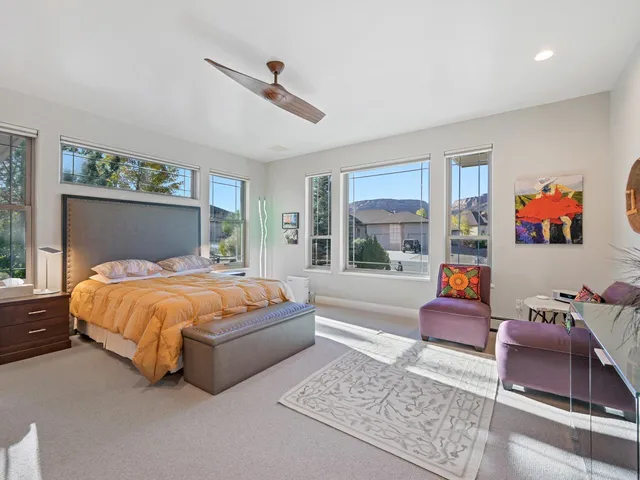 a bed sitting in a bedroom next to a window