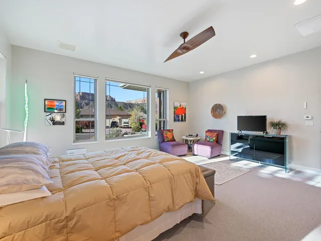 a bedroom with a bed and a flat screen tv