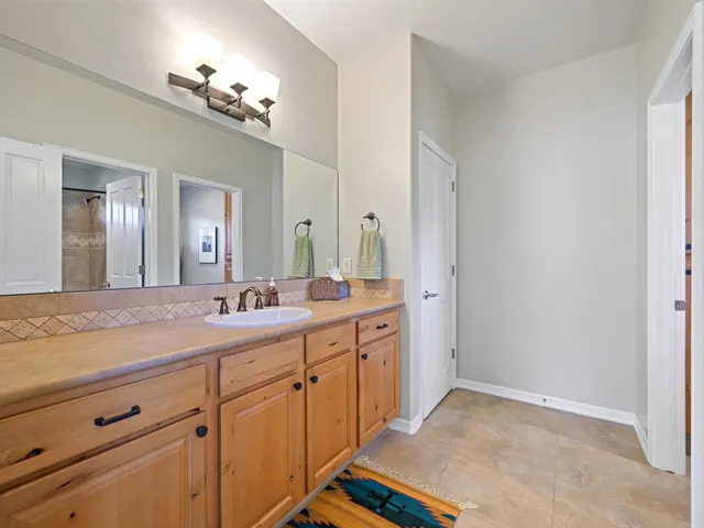 a bathroom with a sink a vanity and a mirror