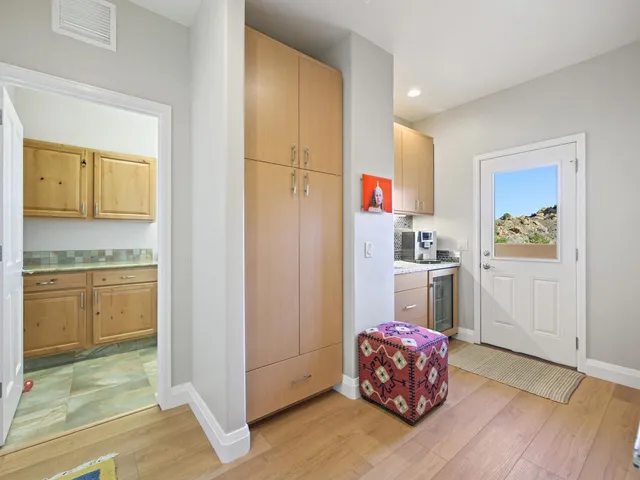 a kitchen with cabinets and wooden floor