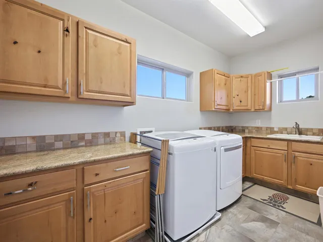 a view of a kitchen with sink and cabinets