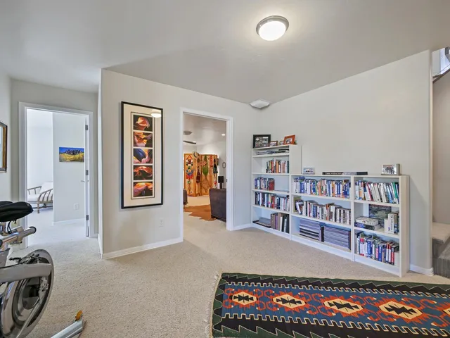 a living room with lots of furniture and baby book shelf