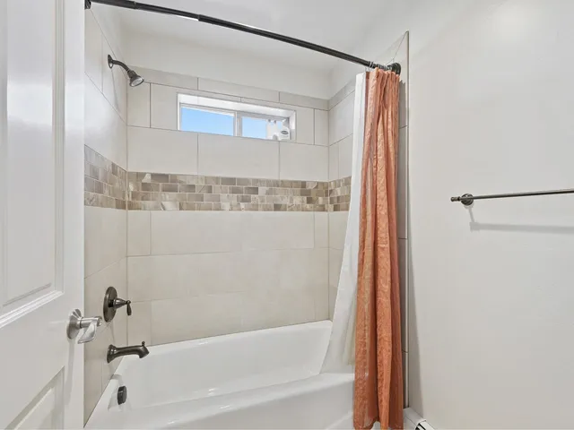 a bathroom with a bathtub and a shower