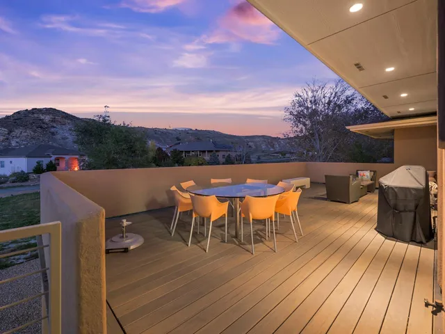 an outdoor sitting area with furniture and wooden floor