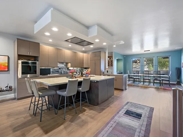 a large kitchen with a table and chairs in it