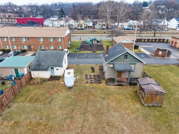 an aerial view of a house with swimming pool and outdoor seating