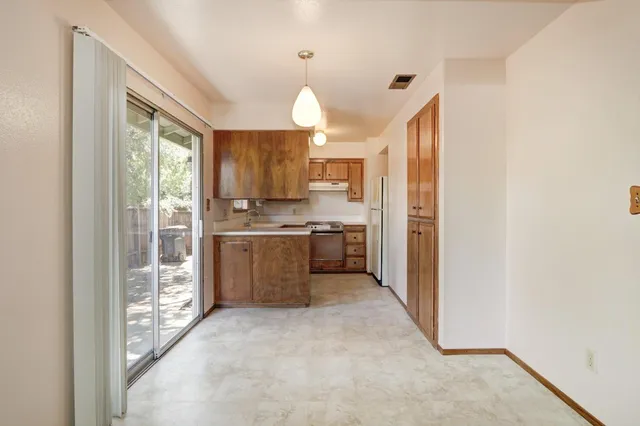 a kitchen with stainless steel appliances granite countertop a sink and a microwave