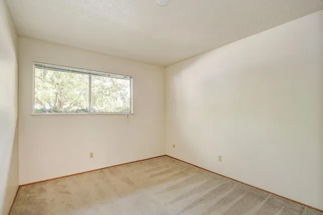 a view of a house with a backyard and sitting area