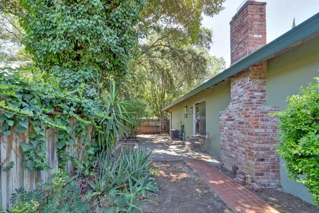 a backyard of a house with table and chairs