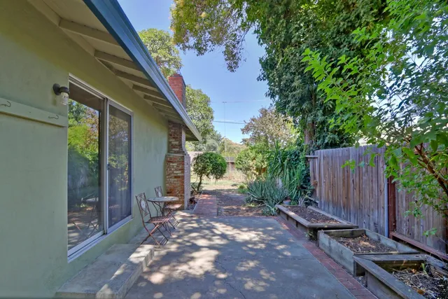 a view of a dining room with furniture large windows and wooden floor