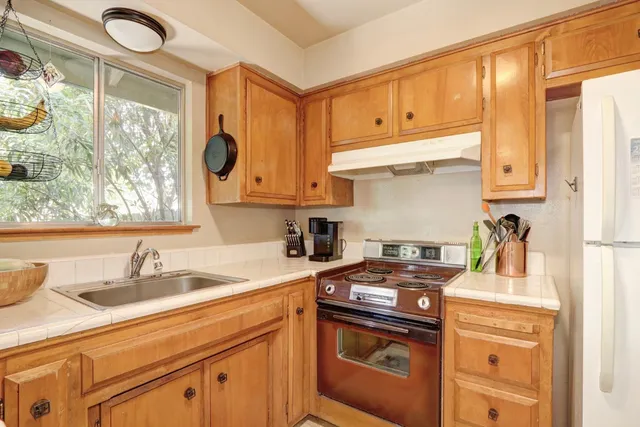 a bedroom with a bed and a lamp on dresser