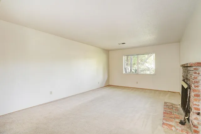 a view of a kitchen with refrigerator and a sink