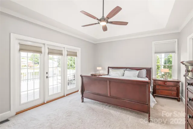 a bed room with a bed and a large window