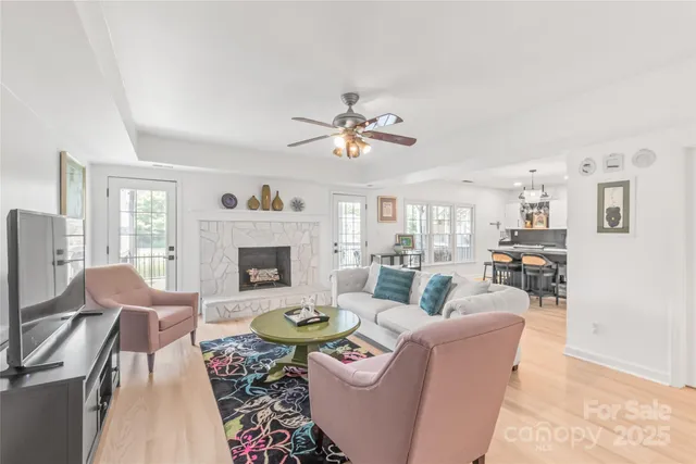 a living room with furniture a fireplace and a flat screen tv