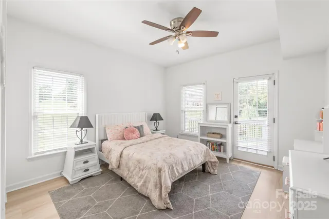 a bedroom with a bed and a large window