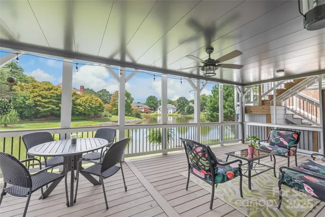 a view of a chairs and table in patio with a lake view