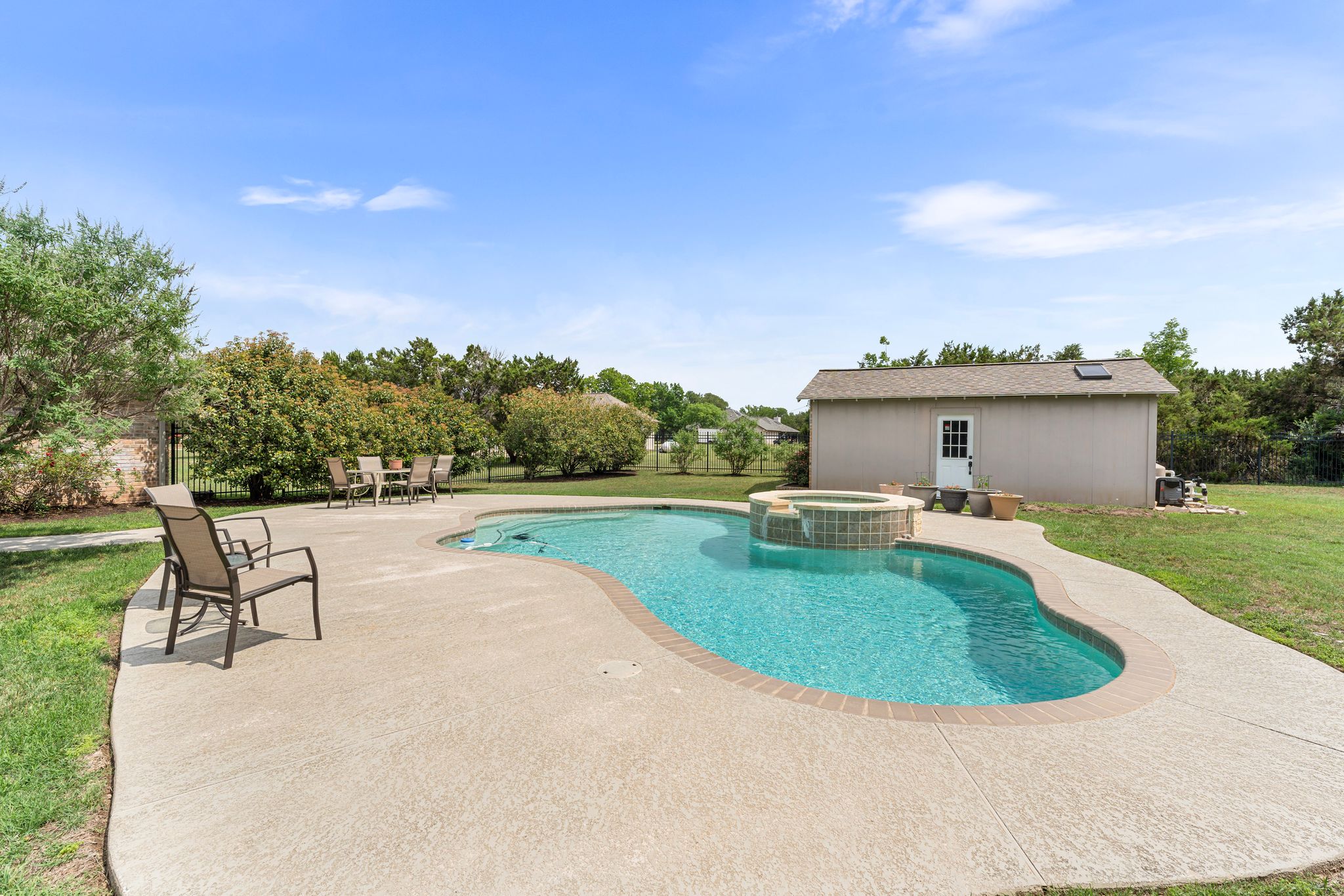 221 Breakaway Road Cedar Park, TX 78613 - Photo 13 of 39 View of swimming pool with a patio area, a yard, an outdoor structure, and a pool with connected hot tub