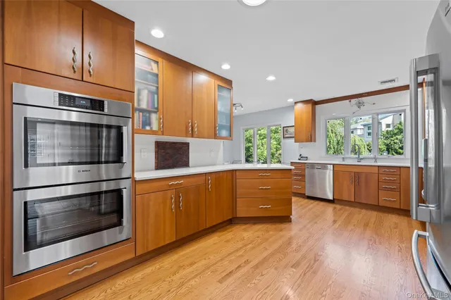 a kitchen with stainless steel appliances kitchen island granite countertop a stove a sink and a microwave