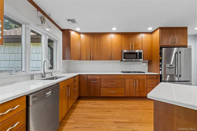 a kitchen with stainless steel appliances granite countertop a sink stove and refrigerator