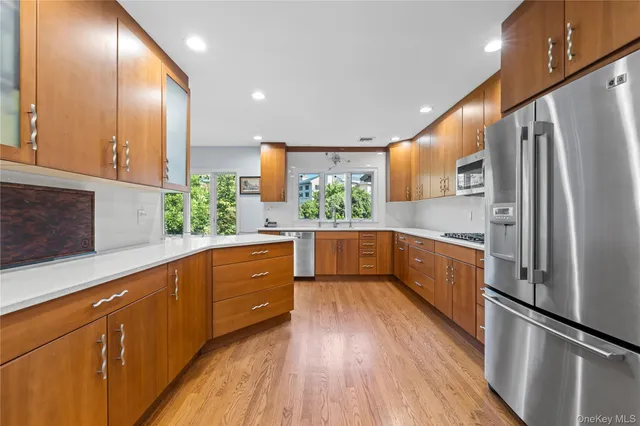 a kitchen with stainless steel appliances a refrigerator and a sink
