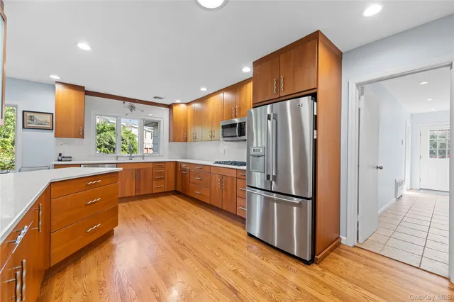 a kitchen with stainless steel appliances granite countertop a refrigerator and a sink