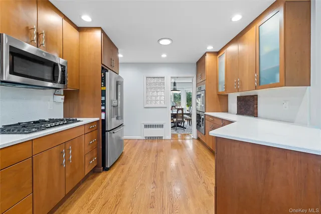 a kitchen with stainless steel appliances a stove a sink and a refrigerator